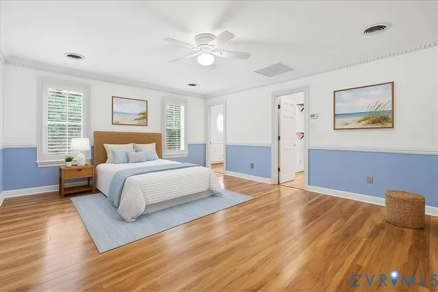 a bedroom with a large bed and a chandelier