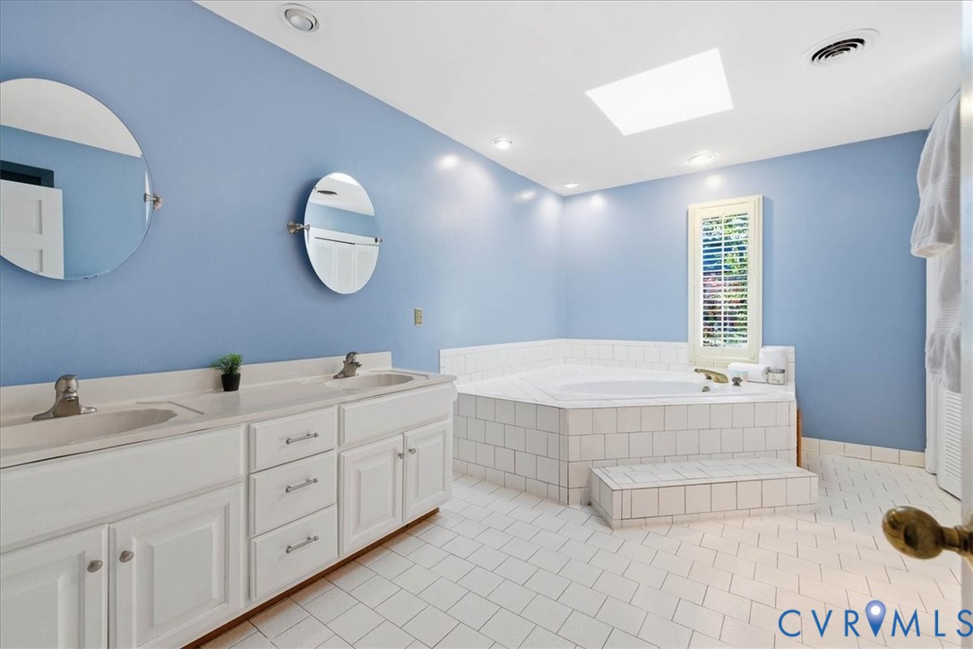 503 Prince George Avenue Hopewell, VA 23860 - Photo 17 of 25 a spacious bathroom with a double vanity sink mirror and bathtub