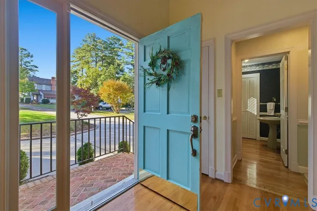 a view of a hallway view with wooden floor and dining room