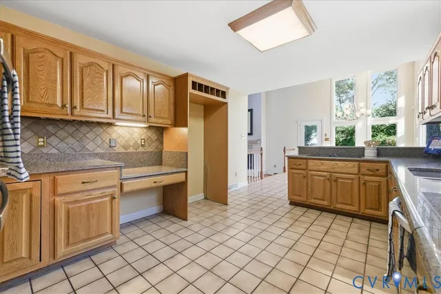 a kitchen with stainless steel appliances granite countertop a sink and cabinets