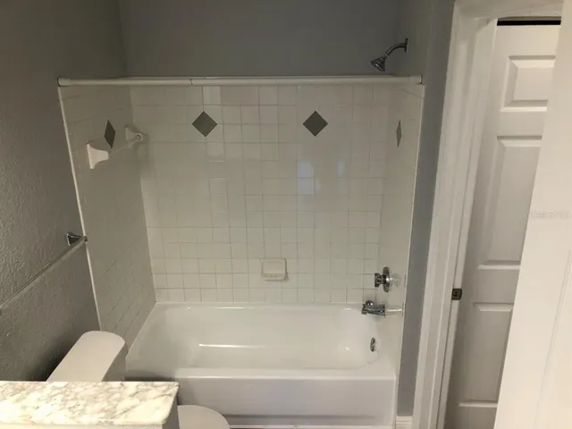 a bathroom with a tub and a shower