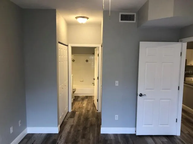a view of a hallway with wooden floor