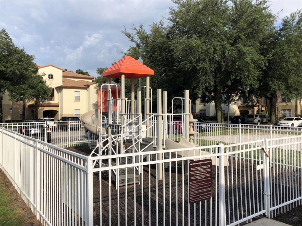 831 Camargo Way, Unit 302 Altamonte Springs, FL 32714 - Photo 18 of 28 a view of a chair and table with an umbrella