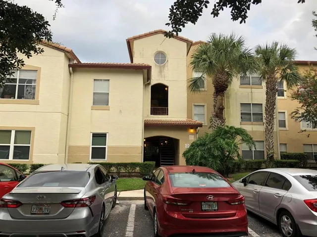 a front view of a house with car parked