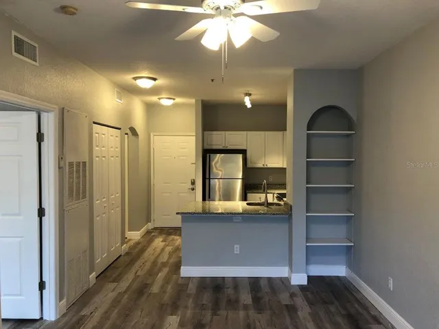 a view of kitchen with cabinets and wooden floor