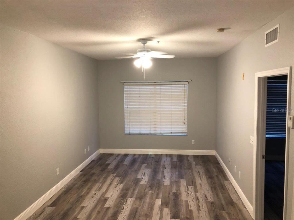 831 Camargo Way, Unit 302 Altamonte Springs, FL 32714 - Photo 10 of 28 wooden floor in an empty room with a window