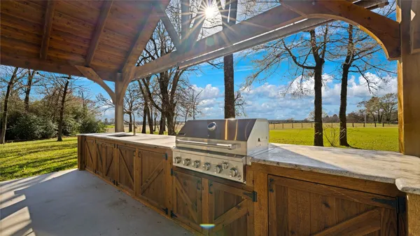 a backyard of a house with barbeque oven
