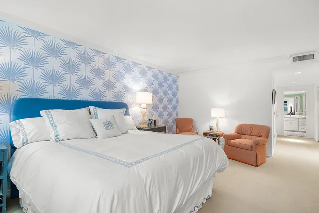 a bed room with large bed and a couch