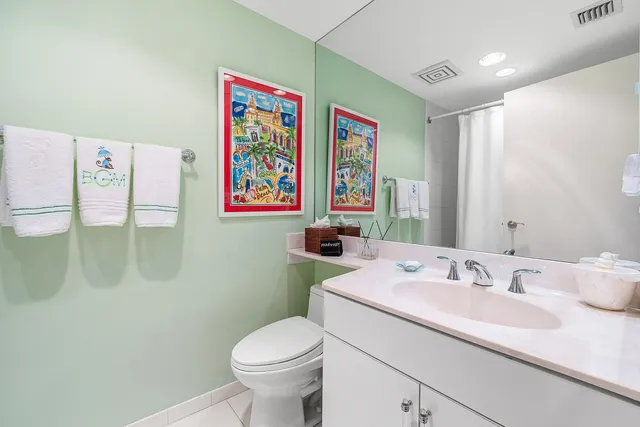 a bathroom with a sink mirror vanity and toilet