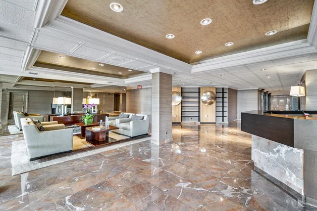 a lobby with furniture and a kitchen