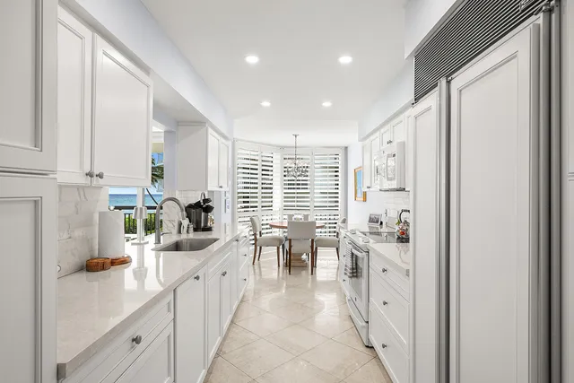 a large white kitchen with lots of counter top space