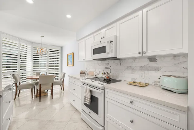 a kitchen with a white cabinets and window