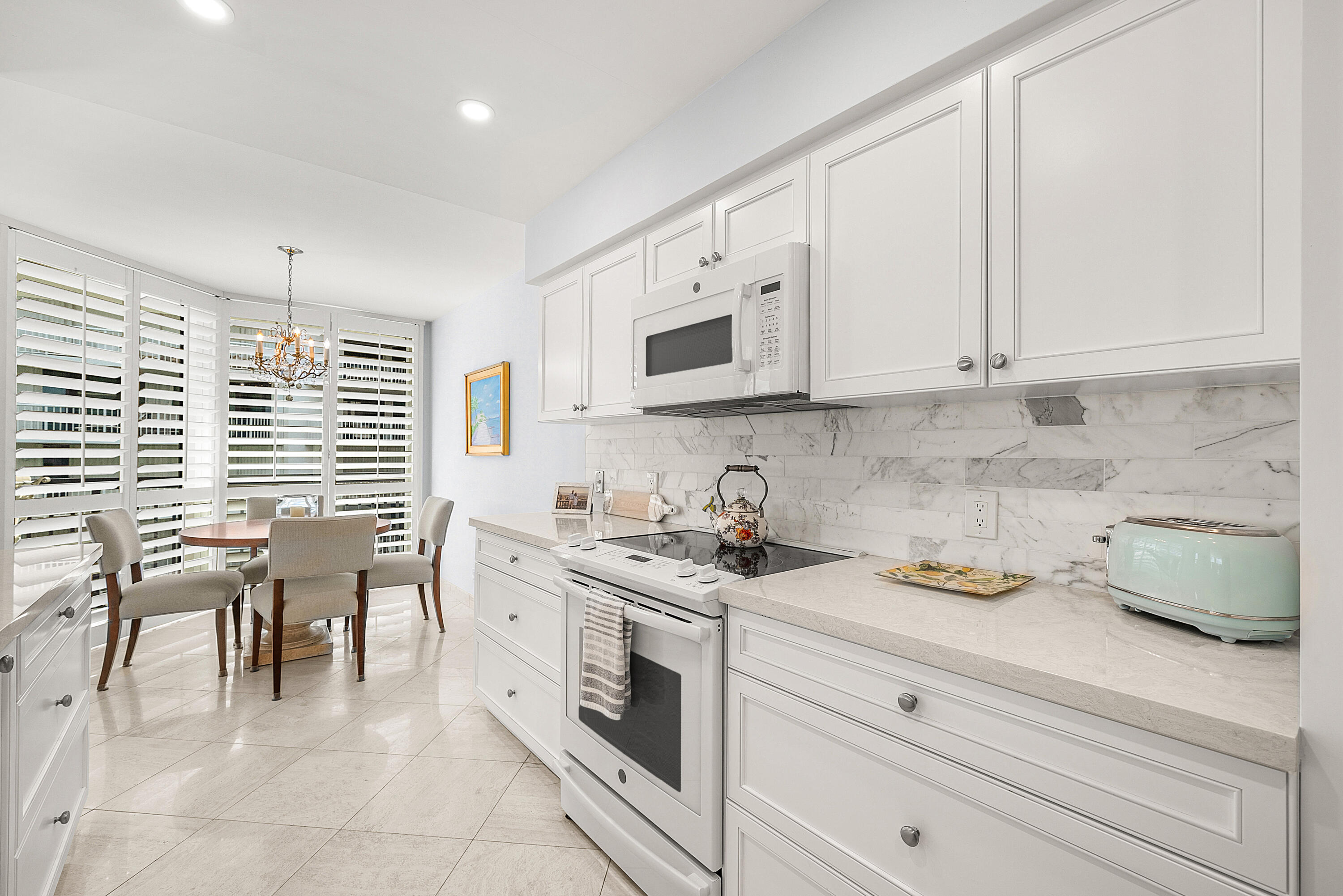 3140 South Ocean Boulevard, Unit 303S Palm Beach, FL 33480 - Photo 6 of 33 a kitchen with a white cabinets and window