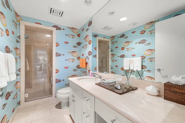 a bathroom with a sink toilet and shower