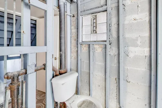 a bathroom with a shower and toilet