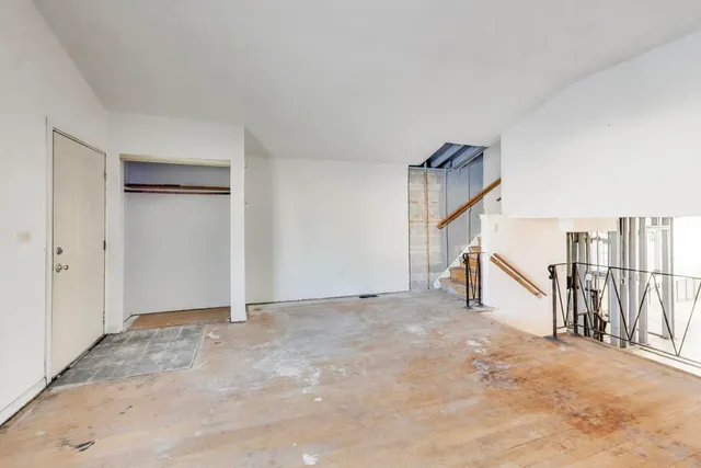 a view of an empty room with stairs