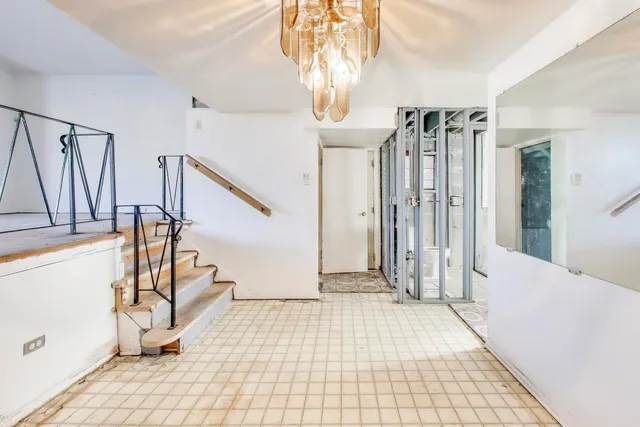 a view of entryway with wooden floor and stairs