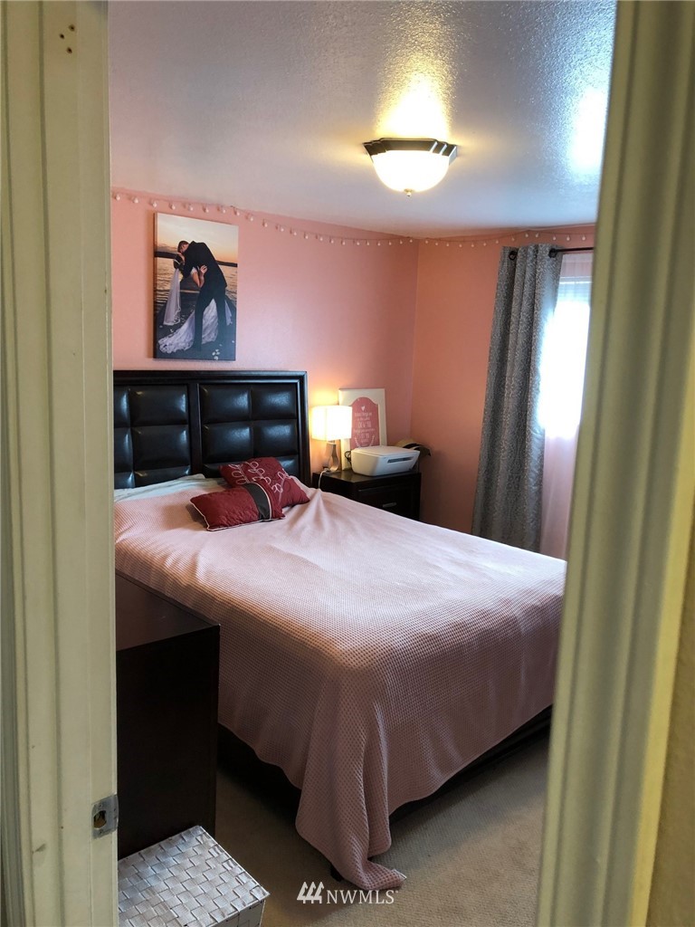 11824 Alexander Road Everett, WA 98204 - Photo 14 of 14 a bedroom with a bed and a painting on the wall