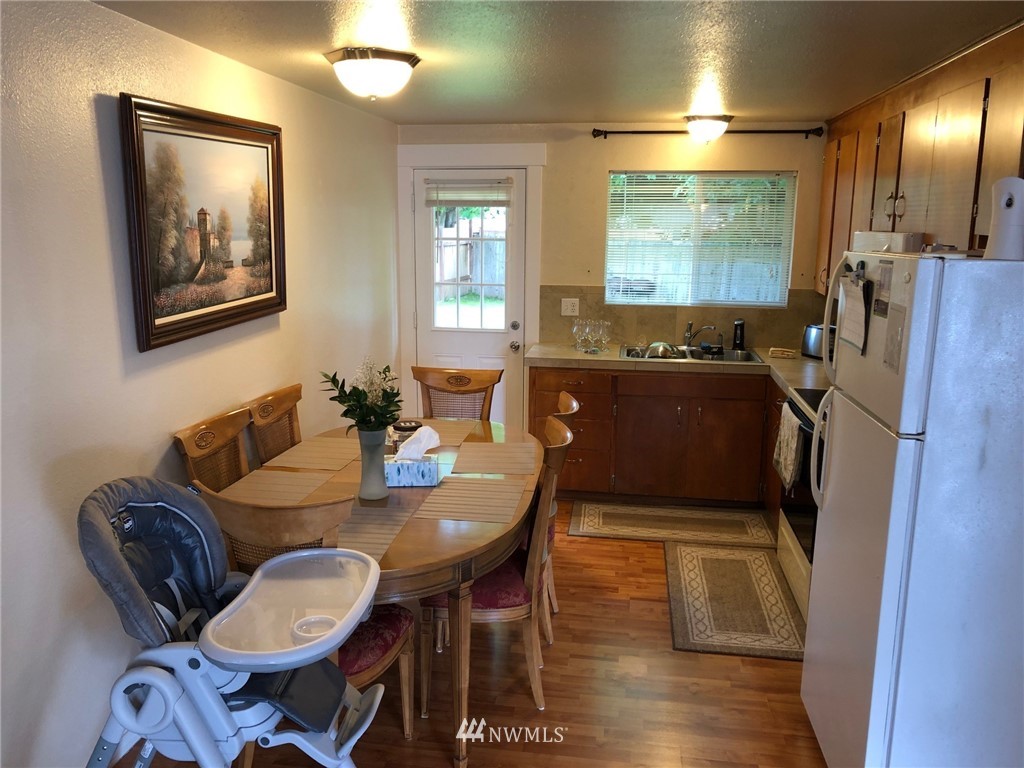 11824 Alexander Road Everett, WA 98204 - Photo 4 of 14 a view of a dining room with furniture window and wooden floor