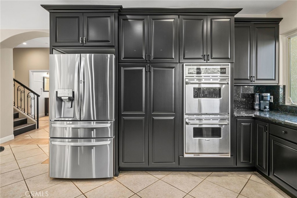 24806 Carlos Place Newhall, CA 91321 - Photo 13 of 56 a kitchen with stainless steel appliances granite countertop a refrigerator and a stove top oven