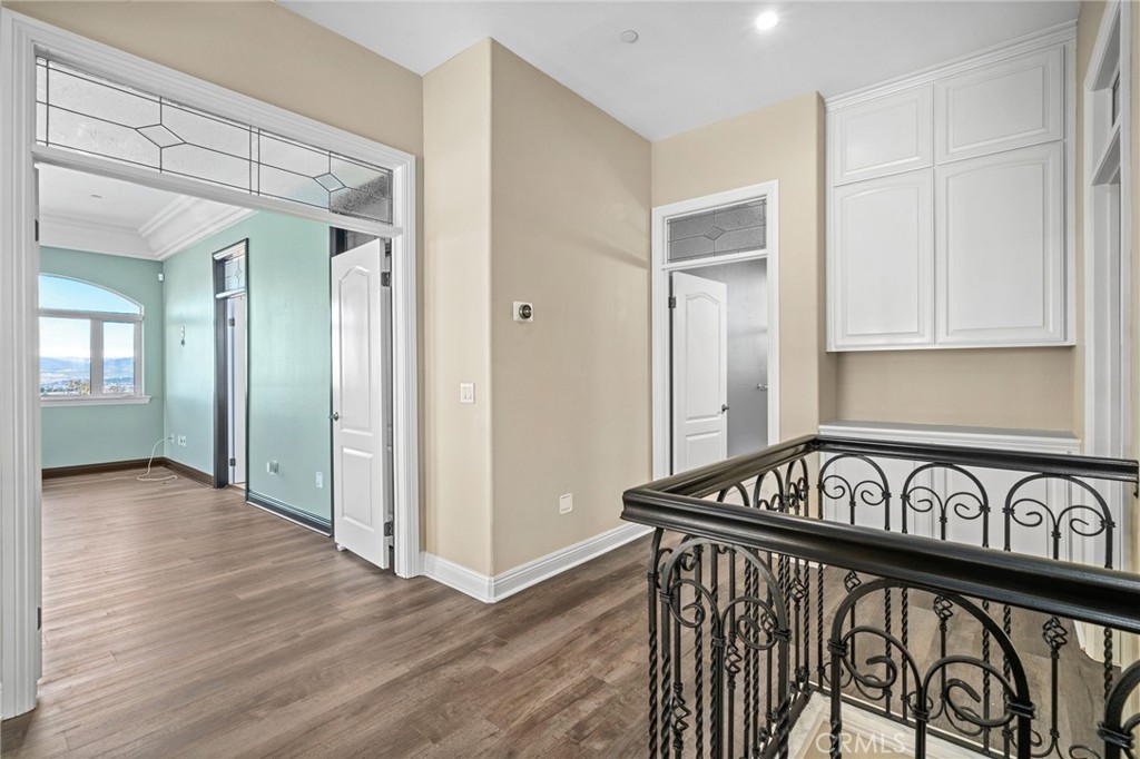 24806 Carlos Place Newhall, CA 91321 - Photo 17 of 56 a view of a hallway with wooden floor and staircase