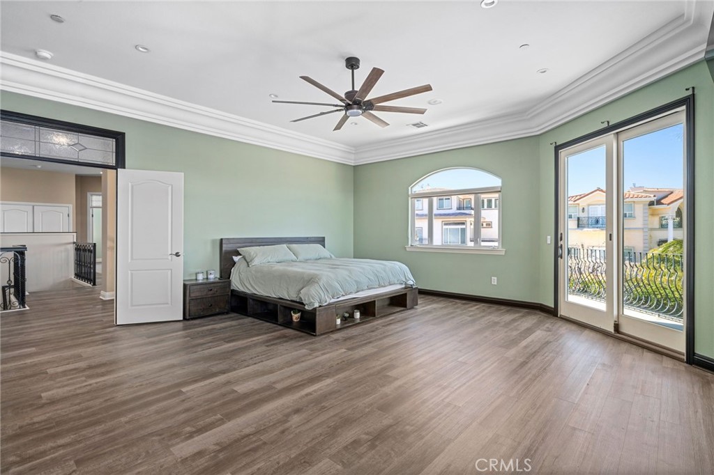 24806 Carlos Place Newhall, CA 91321 - Photo 18 of 56 a spacious bedroom with a bed and wooden floor