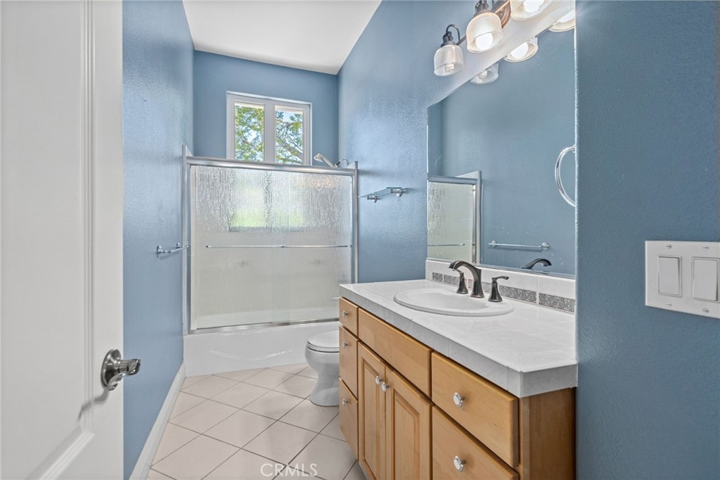 24806 Carlos Place Newhall, CA 91321 - Photo 29 of 56 a bathroom with a sink a vanity and a mirror