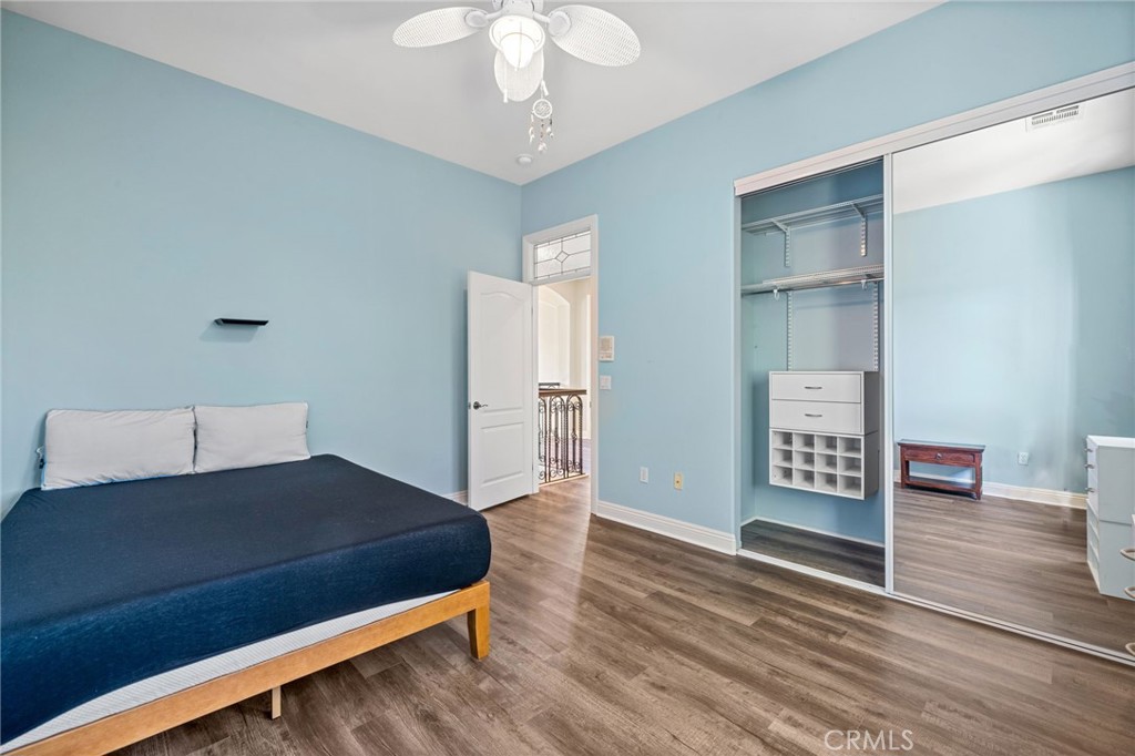 24806 Carlos Place Newhall, CA 91321 - Photo 36 of 56 a living room with a bed furniture and a wooden floor