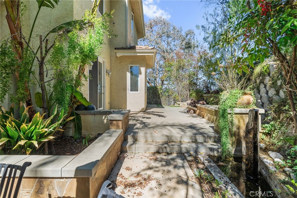 24806 Carlos Place Newhall, CA 91321 - Photo 43 of 56 a view of a house with fountain bath tub and chairs