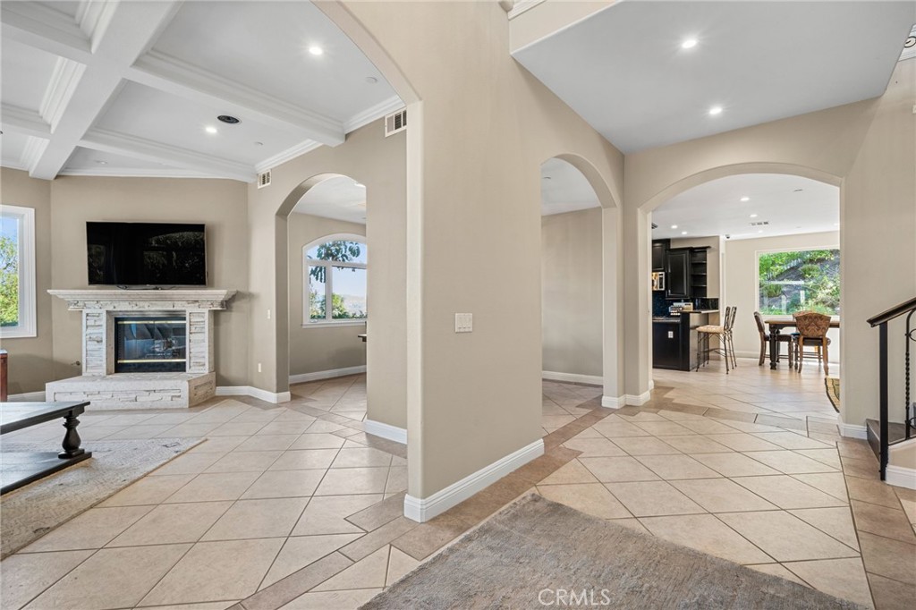 24806 Carlos Place Newhall, CA 91321 - Photo 5 of 56 a view of a livingroom with kitchen and fireplace