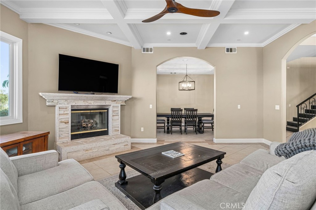 24806 Carlos Place Newhall, CA 91321 - Photo 7 of 56 a living room with furniture a flat screen tv and a fireplace