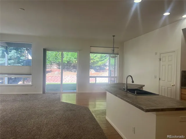 a kitchen with granite countertop a sink and a granite counter tops with a window