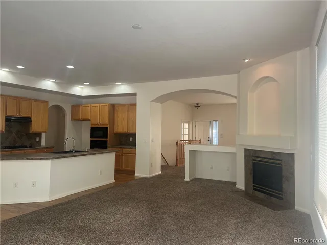 a large kitchen with a sink and a stove top oven