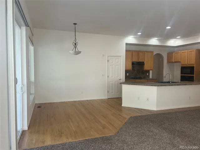 a view of a kitchen with a sink and cabinets