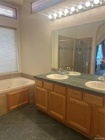 a bathroom with a double vanity sink and a mirror