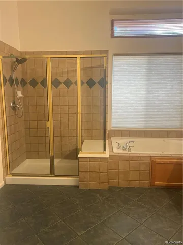 a bathroom with a bathtub and shower