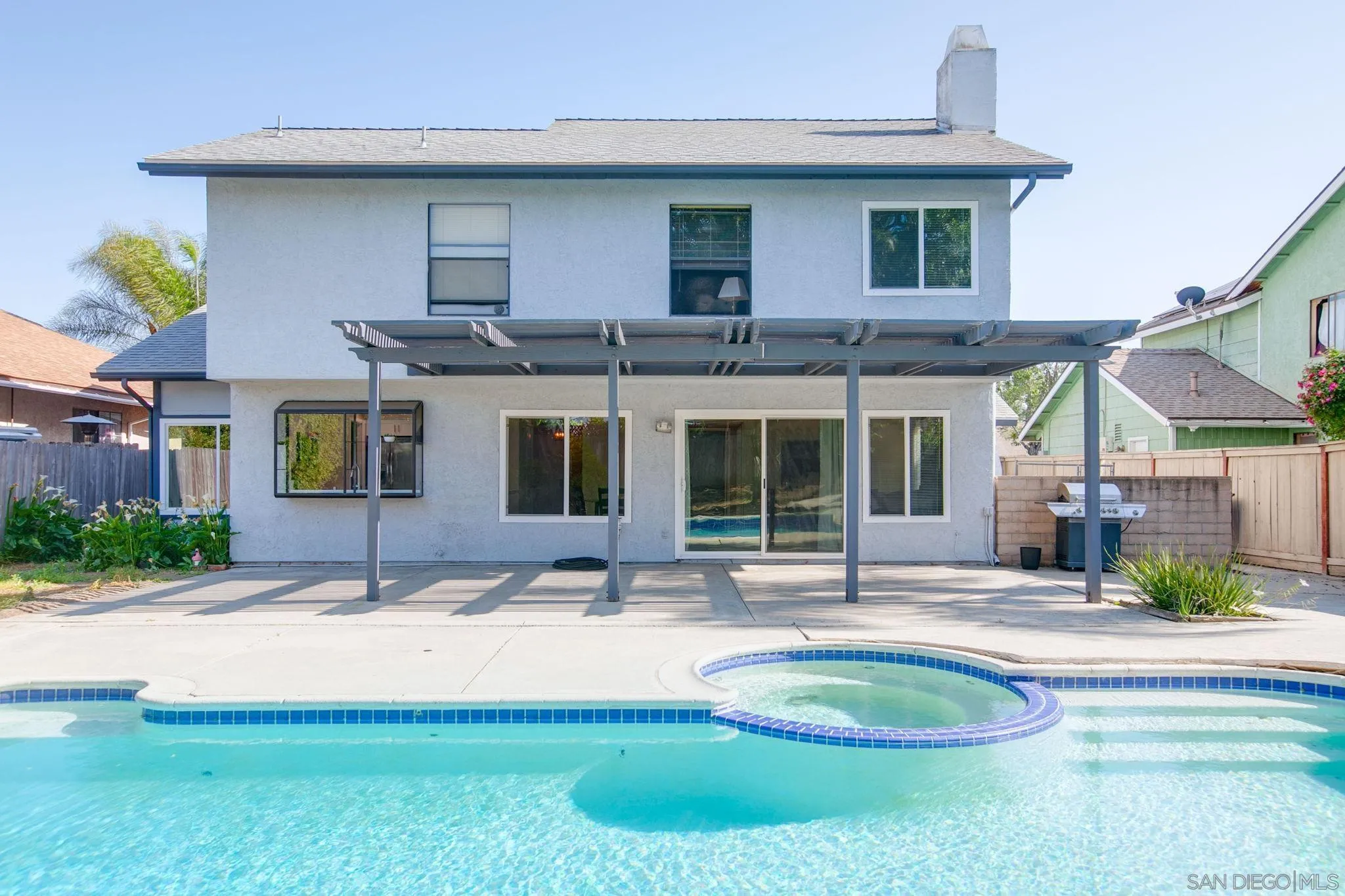 a view of a house with a backyard patio and fire pit
