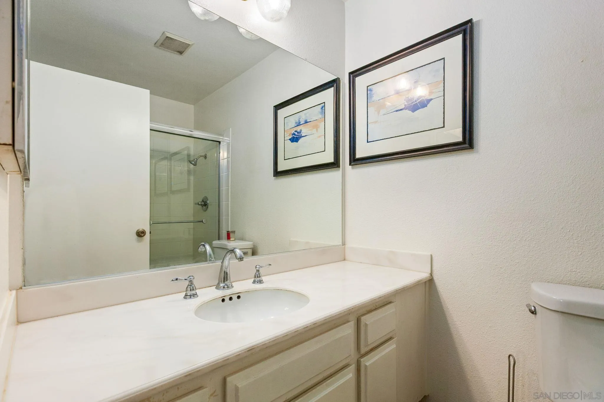 4468 Inverness Drive Oceanside, CA 92057 - Photo 20 of 29 a bathroom with a sink and mirror with toilet