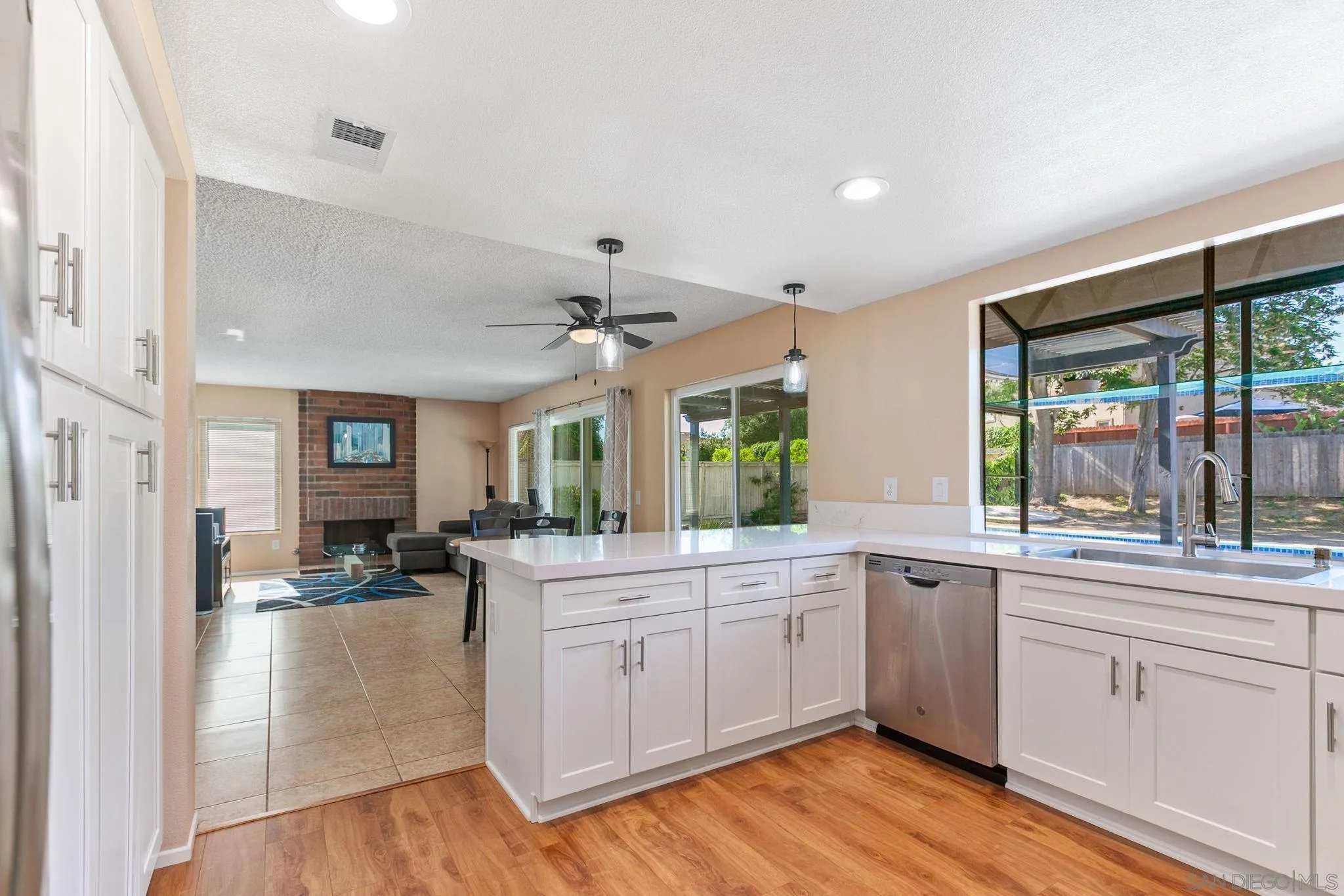 4468 Inverness Drive Oceanside, CA 92057 - Photo 2 of 29 a large white kitchen with a large window a sink and cabinets