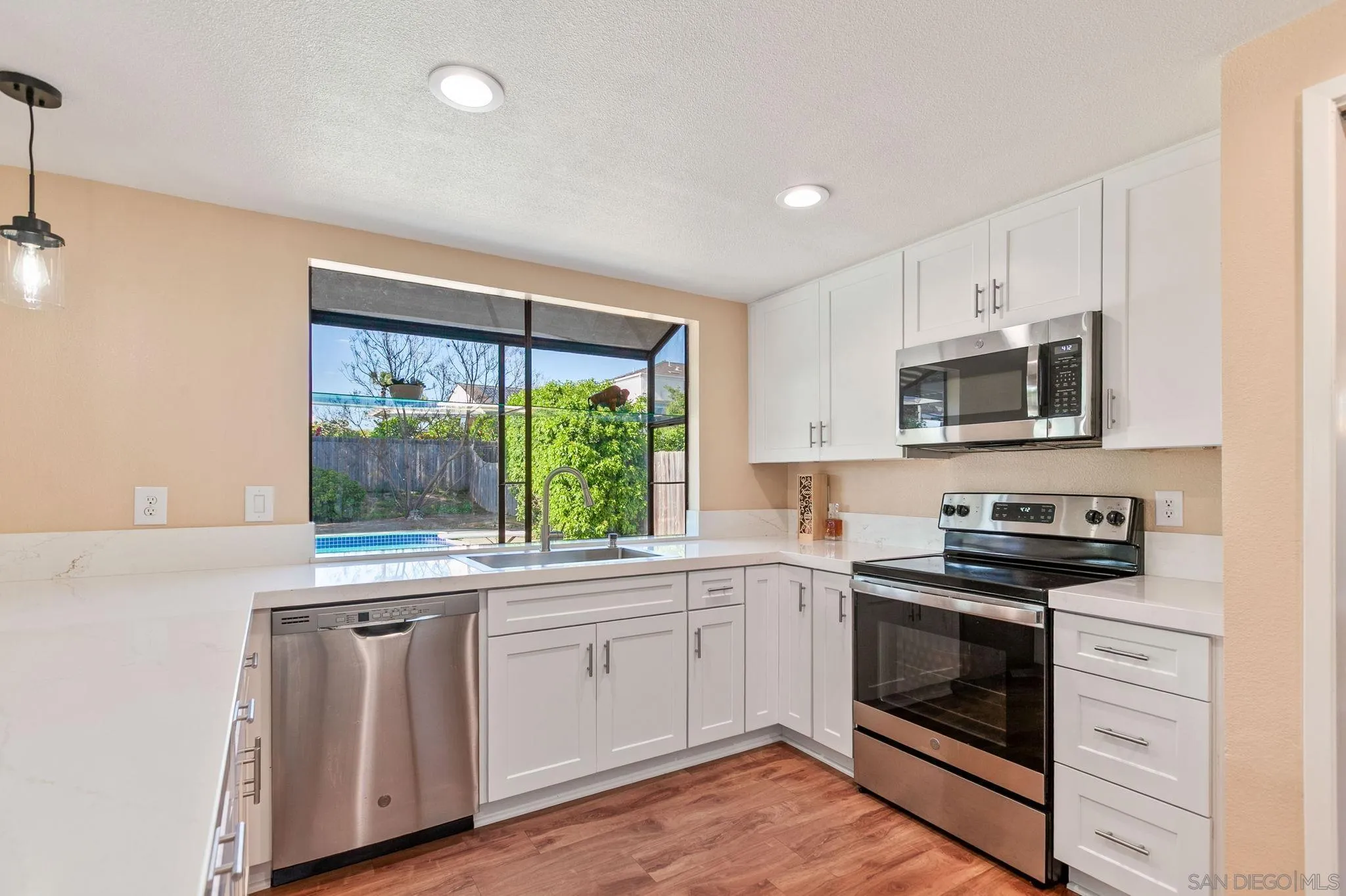 4468 Inverness Drive Oceanside, CA 92057 - Photo 3 of 29 a kitchen with a sink stove and microwave