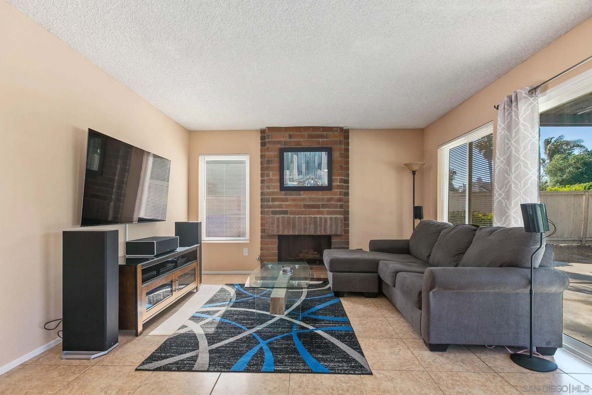 4468 Inverness Drive Oceanside, CA 92057 - Photo 5 of 29 a living room with furniture flat screen tv and a fireplace
