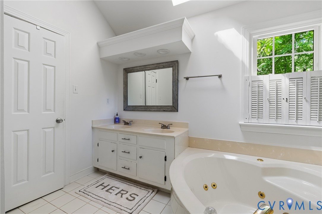 14321 Crossings Ridge Drive Midlothian, VA 23113 - Photo 32 of 43 a bathroom with a bathtub a sink and a window