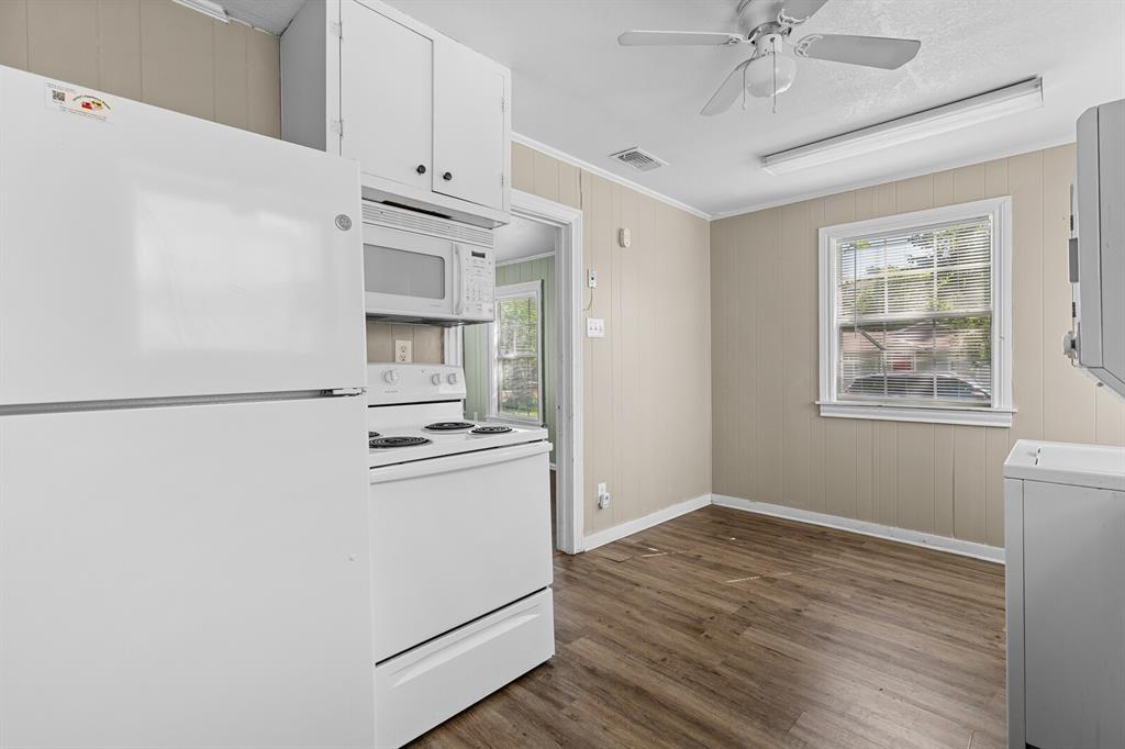1212 Lewis Street Waco, TX 76705 - Photo 7 of 12 a kitchen with granite countertop white cabinets and white appliances