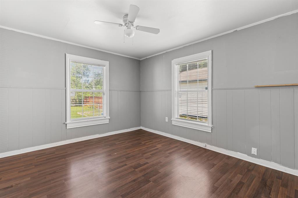 1212 Lewis Street Waco, TX 76705 - Photo 10 of 12 a view of an empty room with wooden floor and a window
