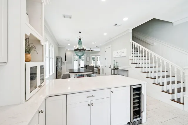 a kitchen with stainless steel appliances a table chairs and a window