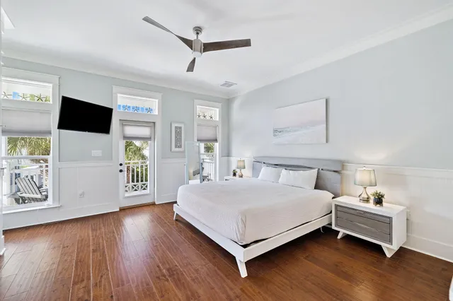 a bedroom with a large bed and a flat tv screen