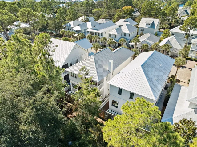 an aerial view of a house with a yard and garden in the back