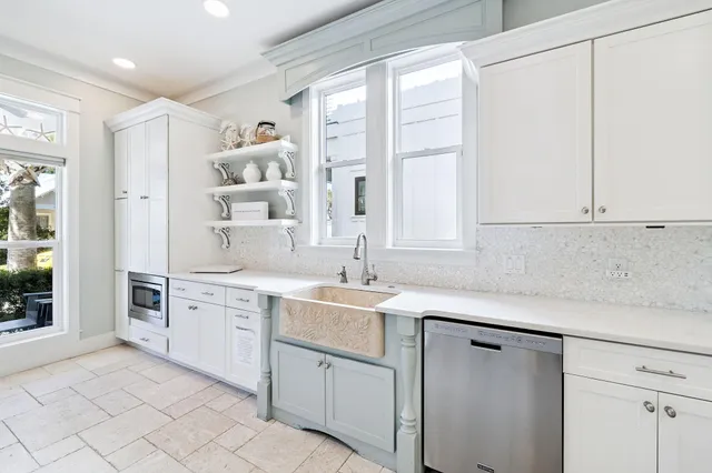 a kitchen with stainless steel appliances granite countertop a stove a refrigerator and a cabinets