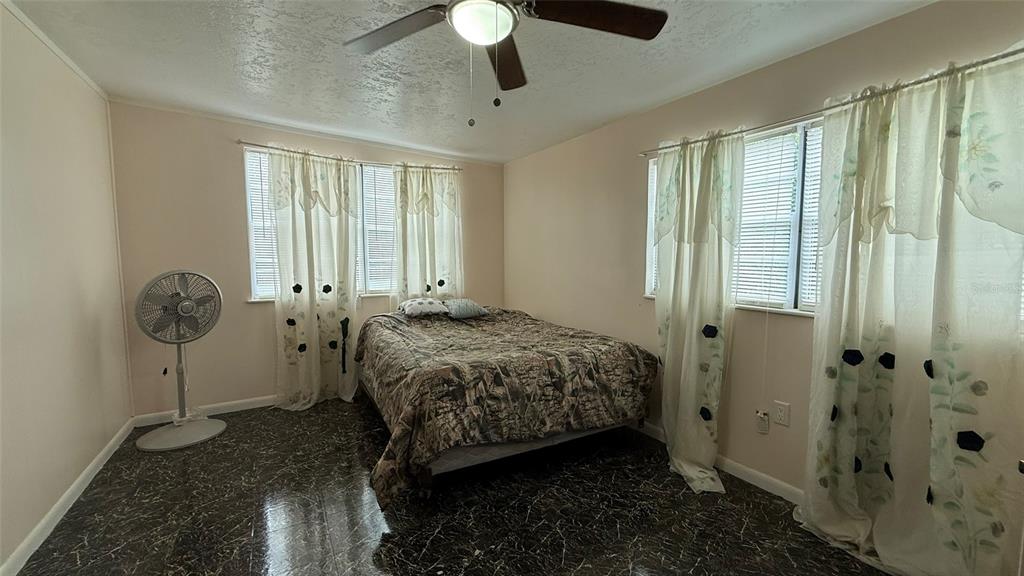 5754 9th Street Zephyrhills, FL 33542 - Photo 14 of 25 a bedroom with a bed and a window