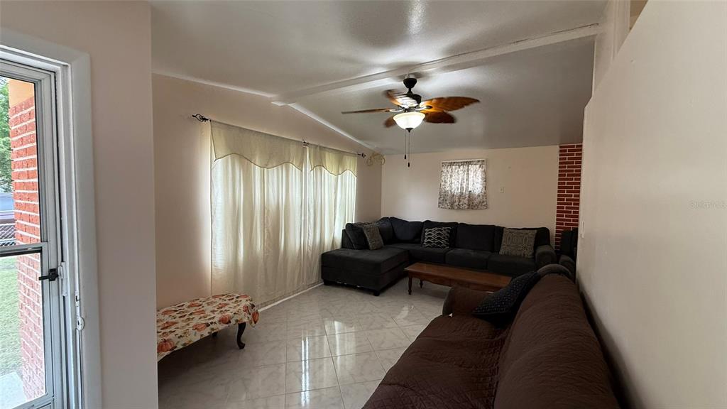 5754 9th Street Zephyrhills, FL 33542 - Photo 3 of 25 a living room with furniture and wooden floor